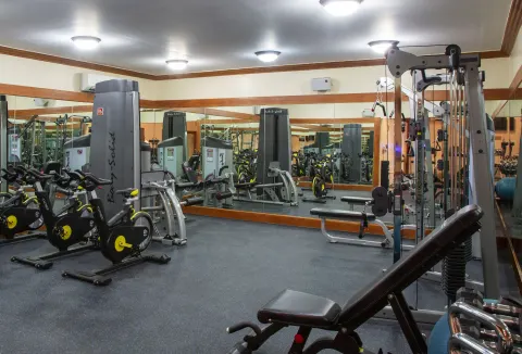 Fitness room with cardio and weight machines at The Club, Barbados Resort & Spa.