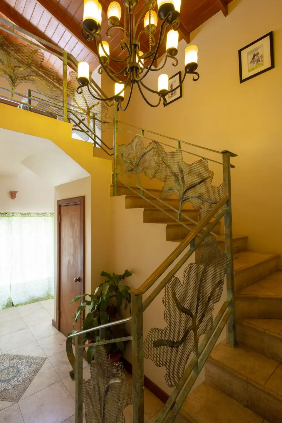 Interior staircase with leaf-pattern railings at The Club, Barbados Resort & Spa.
