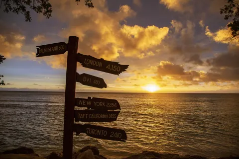 Ocean sunset with directional signpost at The Club, Barbados Resort & Spa.