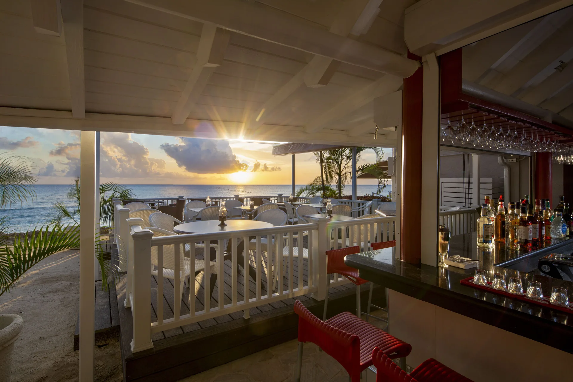 Seaside bar terrace at sunset at The Club, Barbados Resort & Spa.