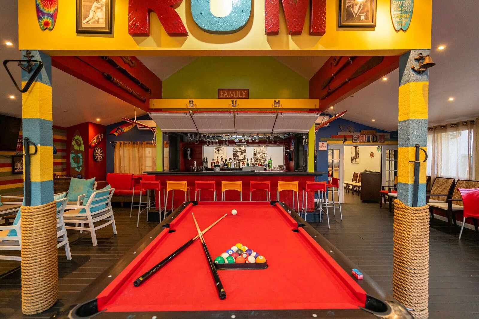 Rum-themed bar with a red pool table at The Club, Barbados Resort & Spa.