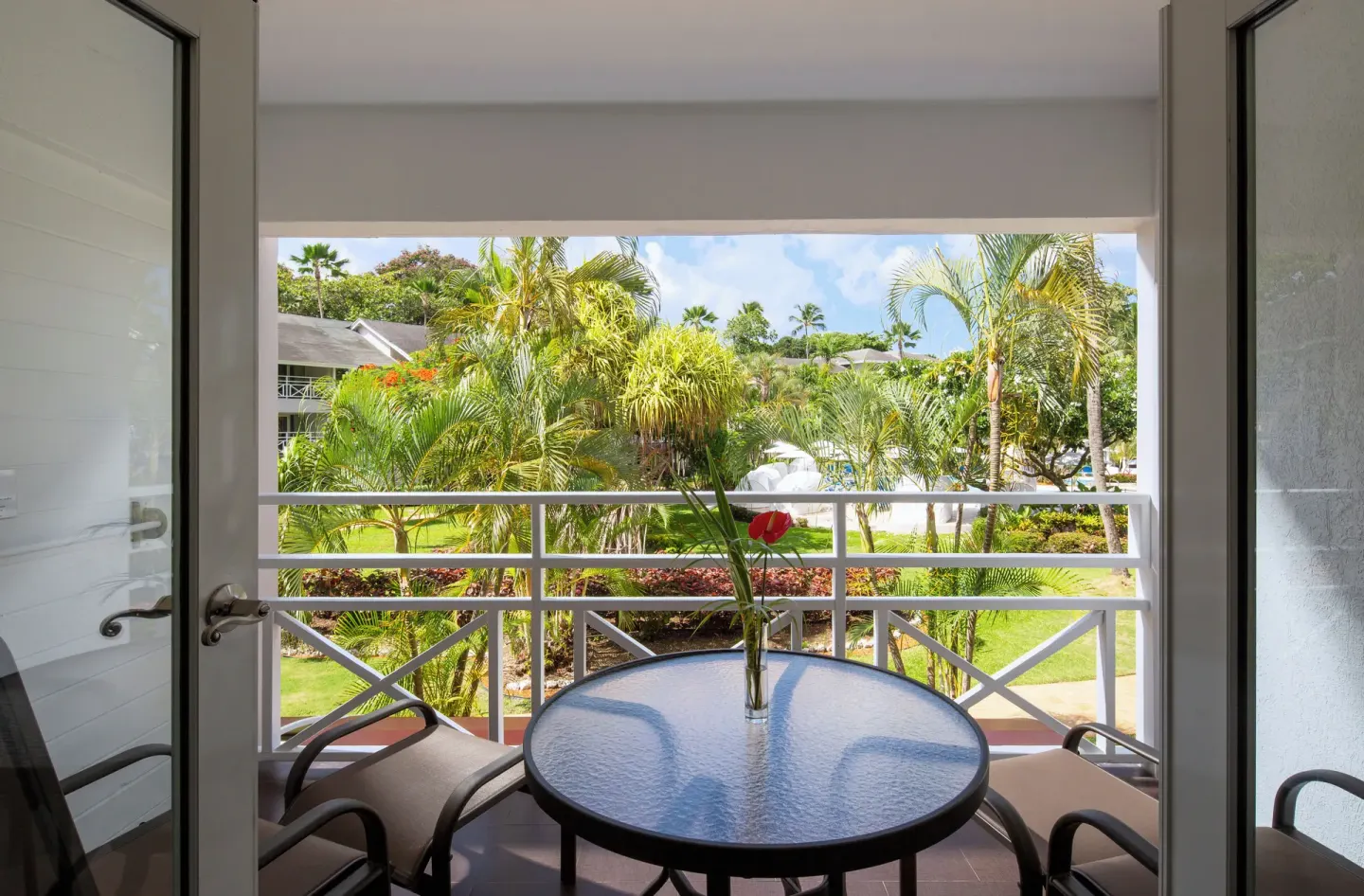 Garden View balcony with table and tropical landscaping at The Club, Barbados Resort & Spa.