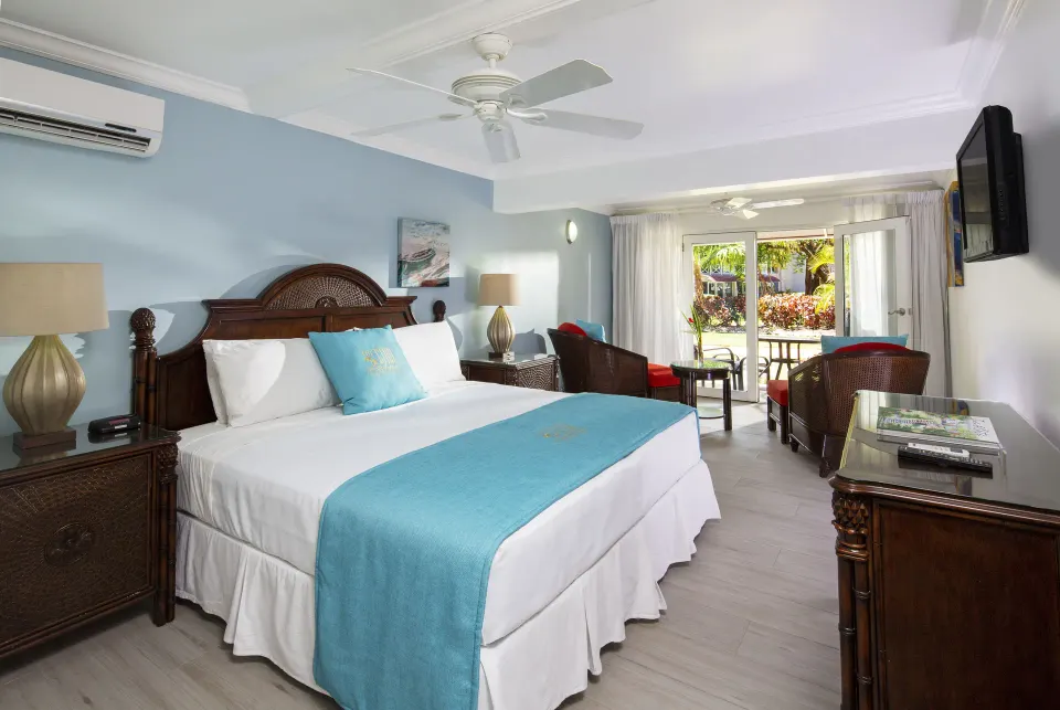 Garden View guest room with king bed and patio doors at The Club, Barbados Resort & Spa.