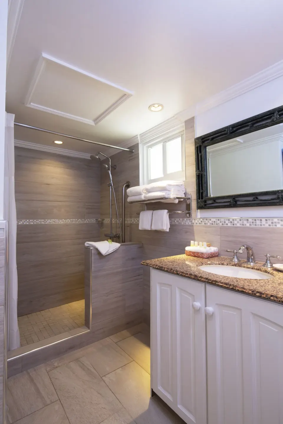 One Bedroom Garden View Suite bathroom with walk-in shower and vanity at The Club, Barbados Resort & Spa.