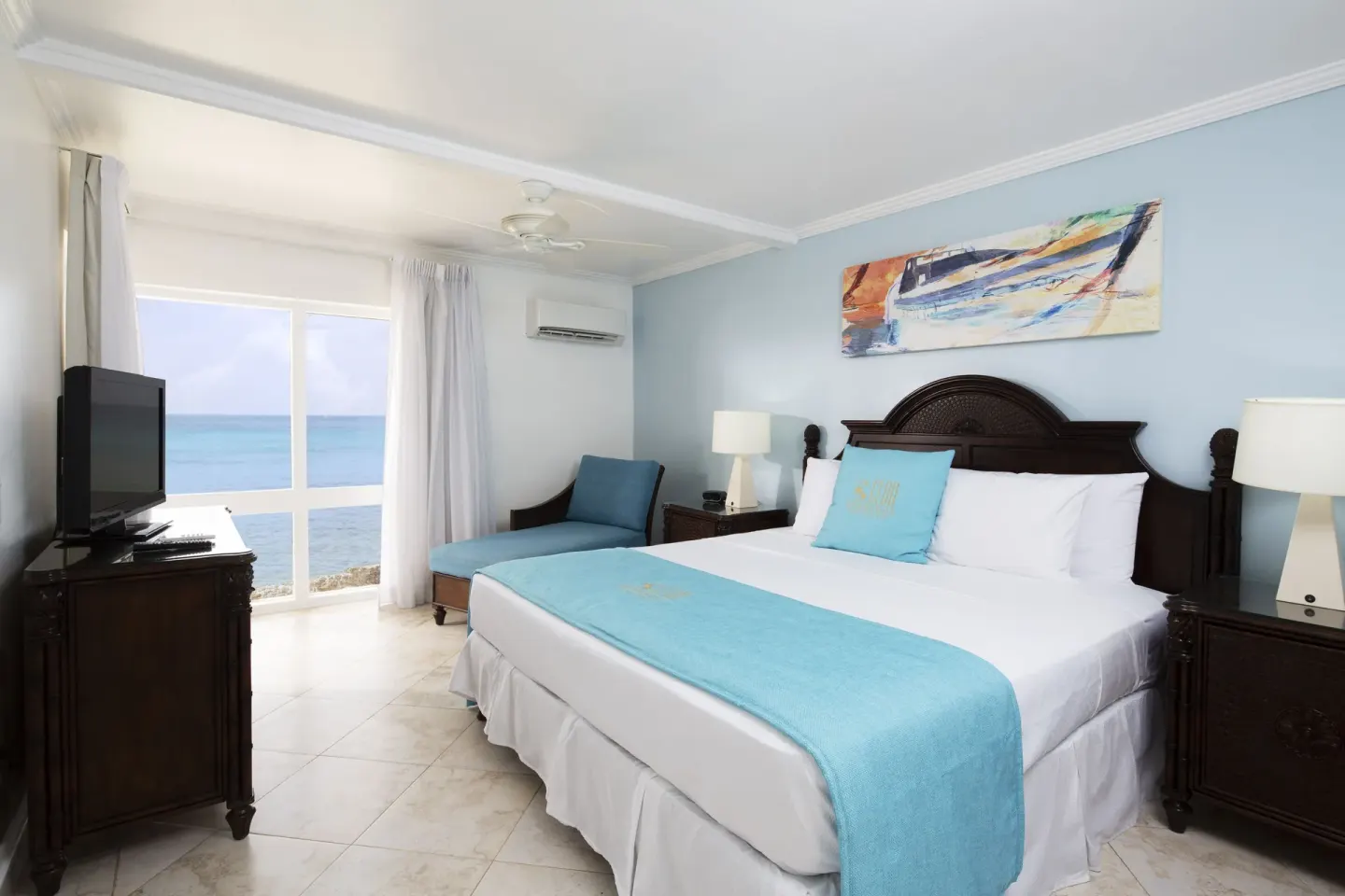 One Bedroom Oceanfront Suite bedroom with king bed and sea view at The Club, Barbados Resort & Spa.