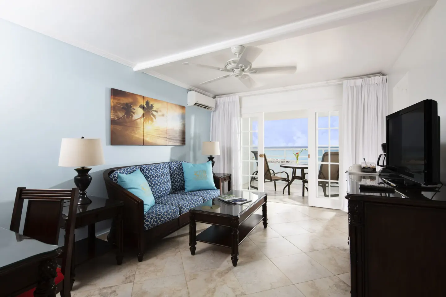 One Bedroom Oceanfront Suite sitting area and balcony doors at The Club, Barbados Resort & Spa.