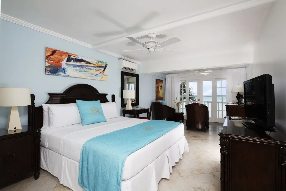 Superior Oceanfront king bed with balcony doors at The Club, Barbados Resort & Spa.