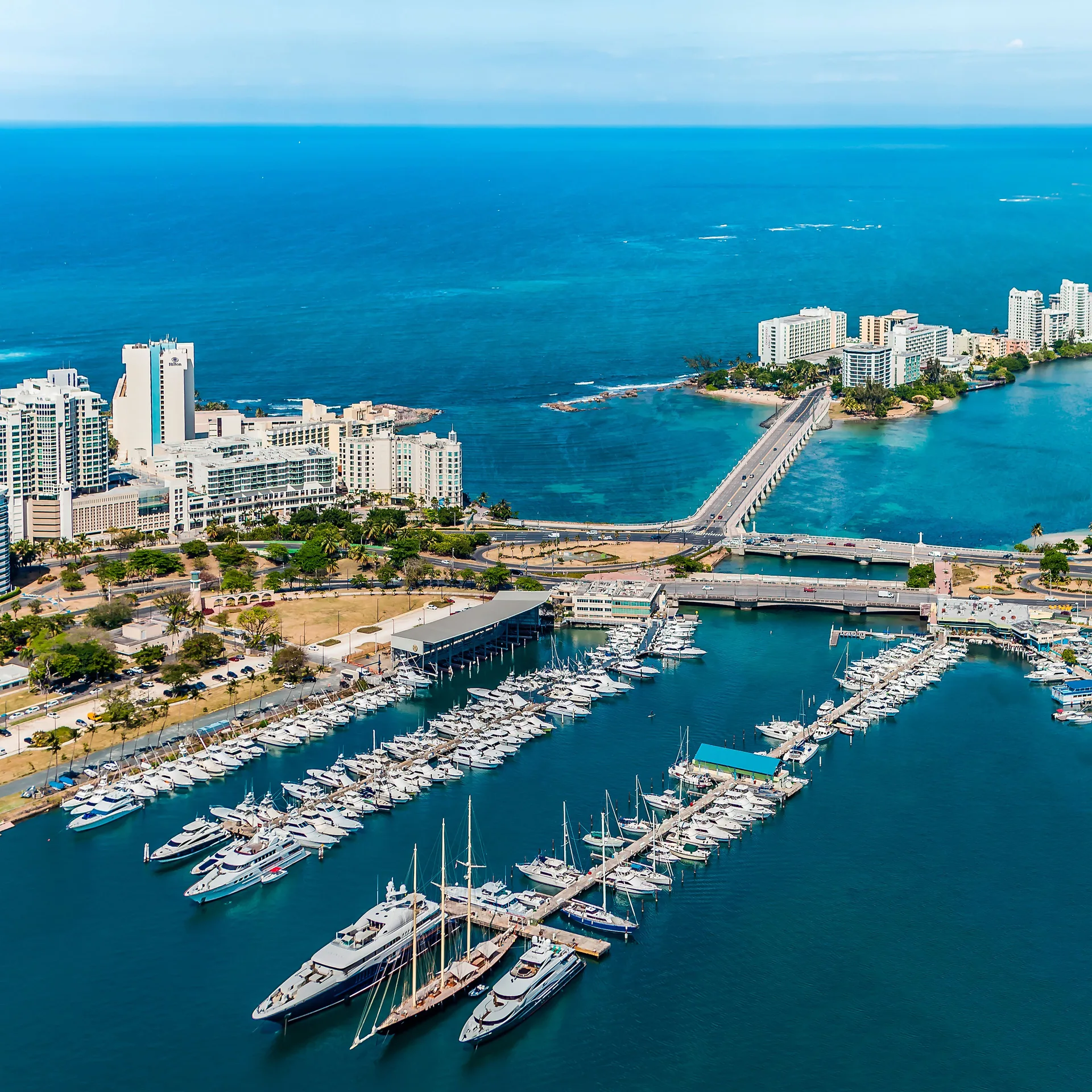 Aerial view of marina, bridges, and blue ocean by The Condado Plaza Hotel.