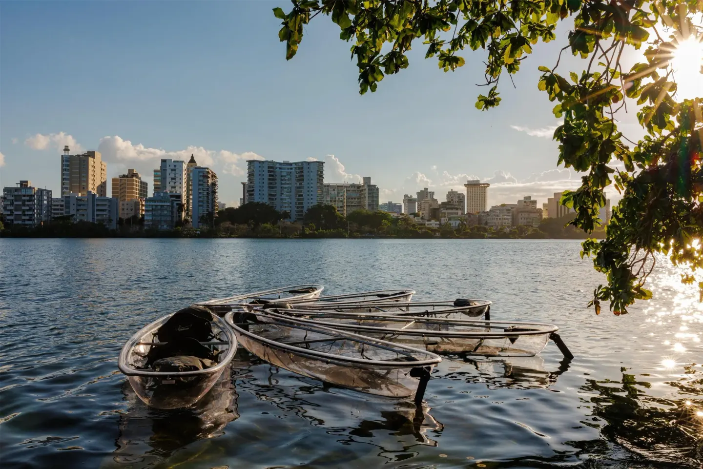 Clear kayaks floating on the lagoon at sunset near The Condado Plaza Hotel.