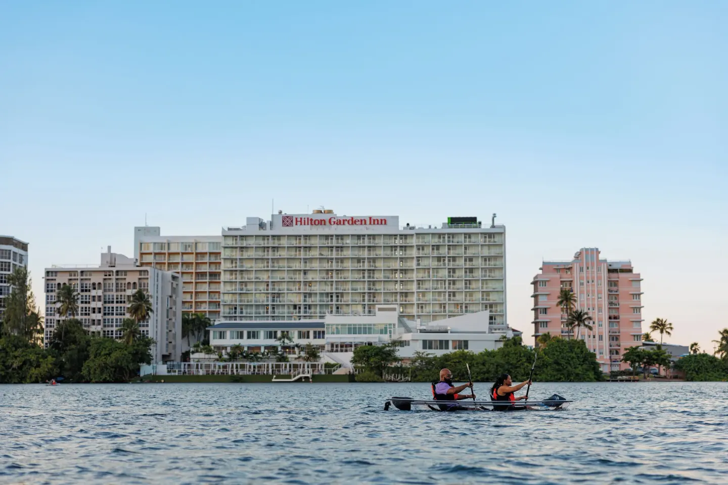 Kayakers paddle across the lagoon in front of The Condado Plaza Hotel.