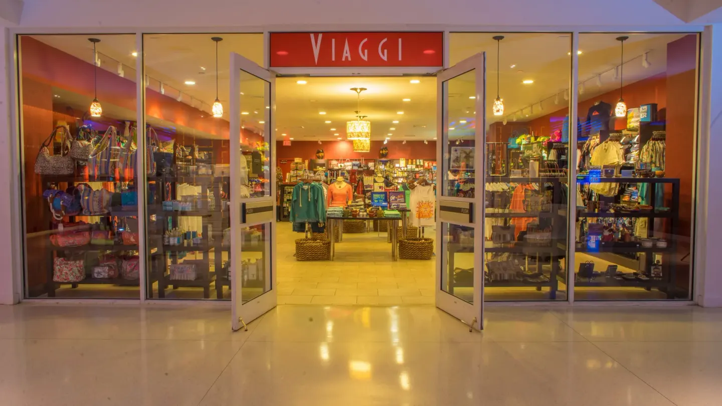 Viaggi storefront at The Condado Plaza Hotel with open glass doors and retail displays.