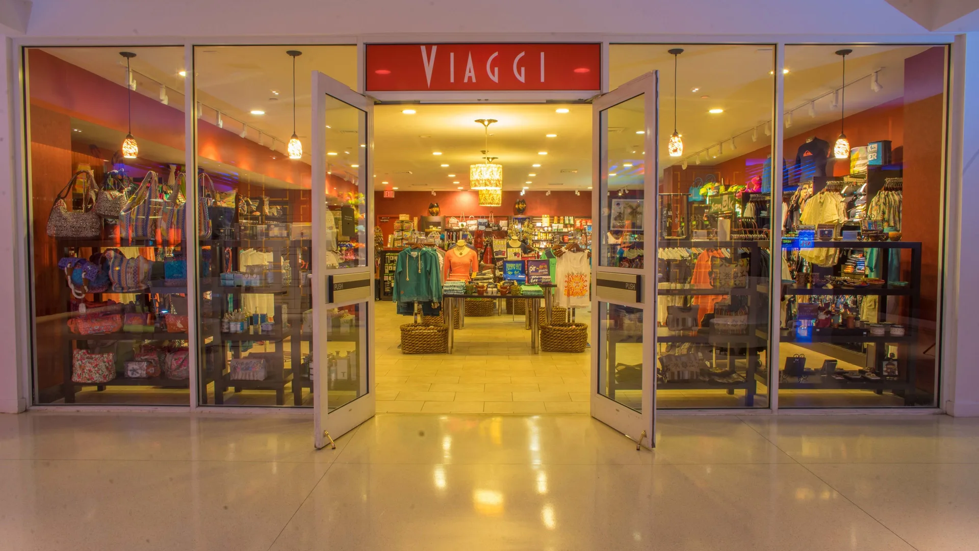 Viaggi storefront at The Condado Plaza Hotel with open glass doors and retail displays.