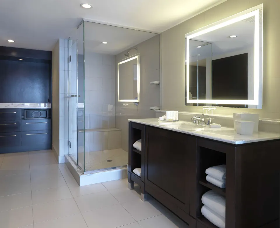 Oceanfront deluxe suite bathroom vanity and glass shower at The Condado Plaza Hotel.