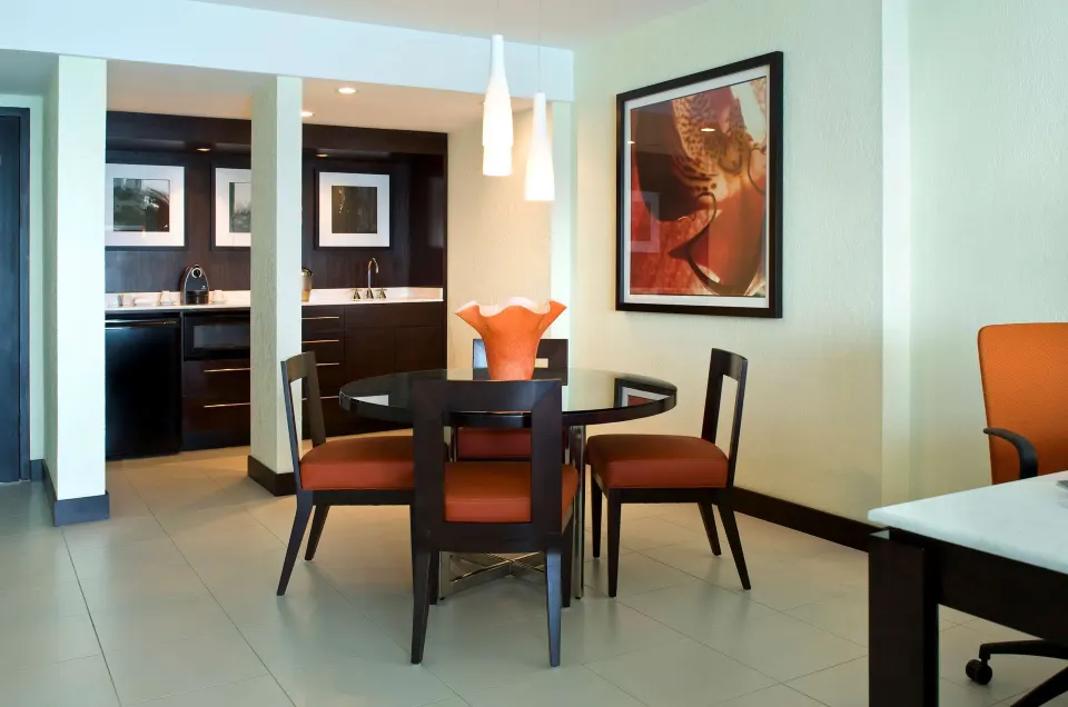 Oceanfront Deluxe Suite dining area and kitchenette at The Condado Plaza Hotel.