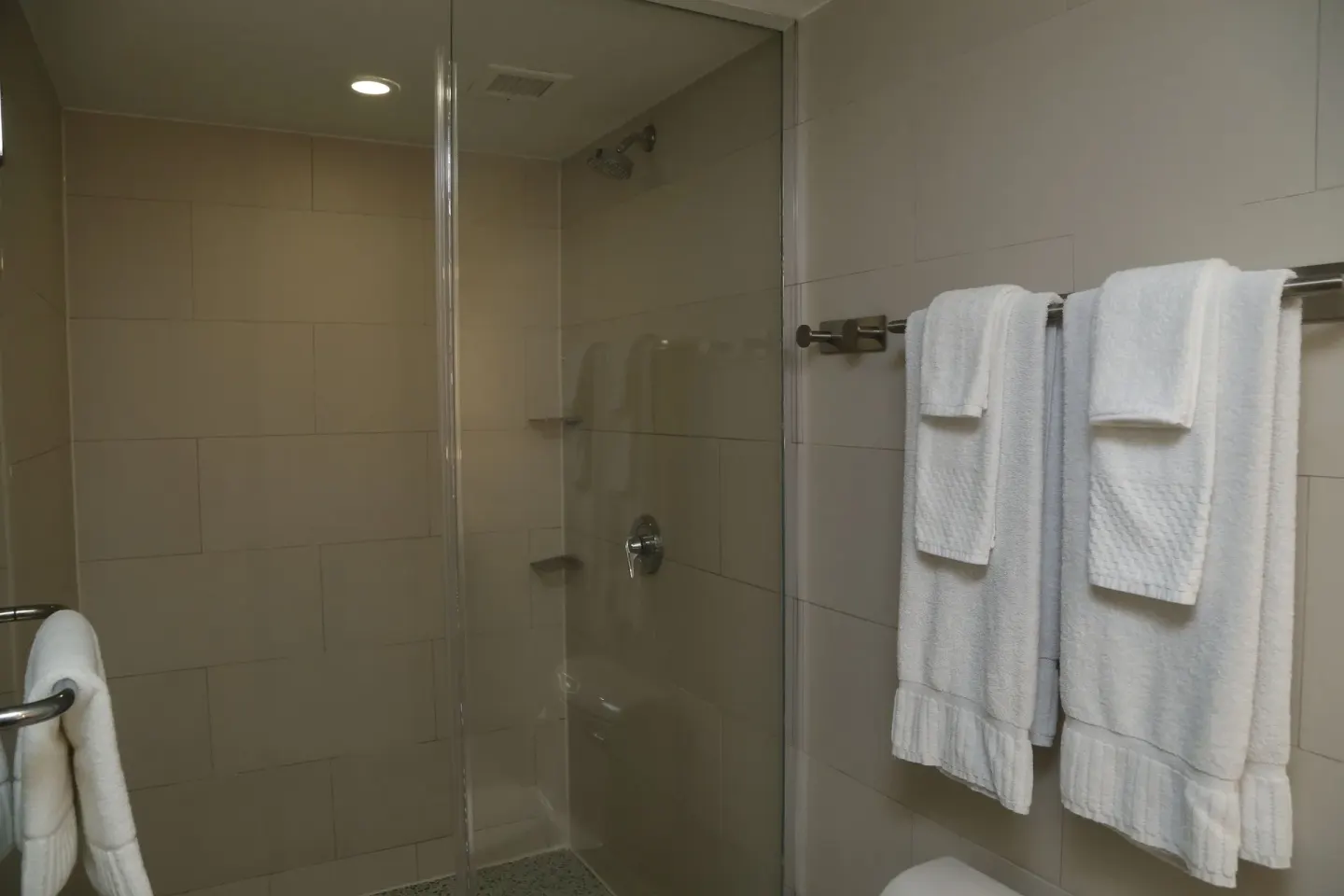 Junior Suite balcony bathroom with glass shower and towels at The Condado Plaza Hotel.