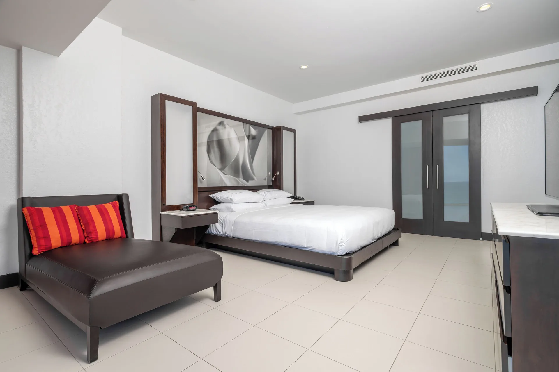 Junior Suite balcony room with king bed and chaise at The Condado Plaza Hotel.