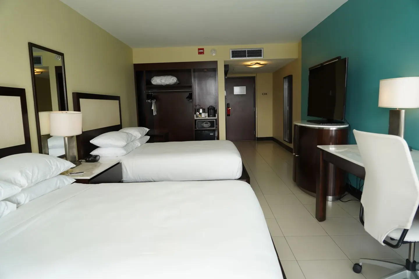 Accessible guest room with two beds, desk, and open closet at The Condado Plaza Hotel.