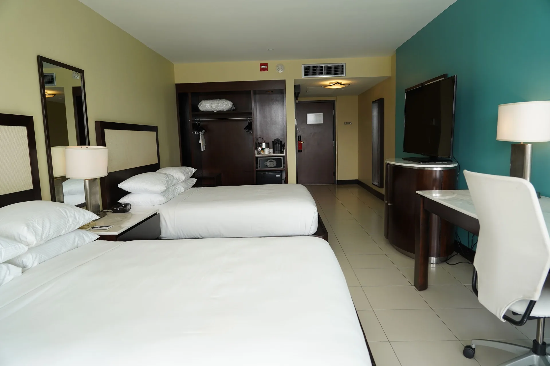 Accessible guest room with two beds, desk, and open closet at The Condado Plaza Hotel.