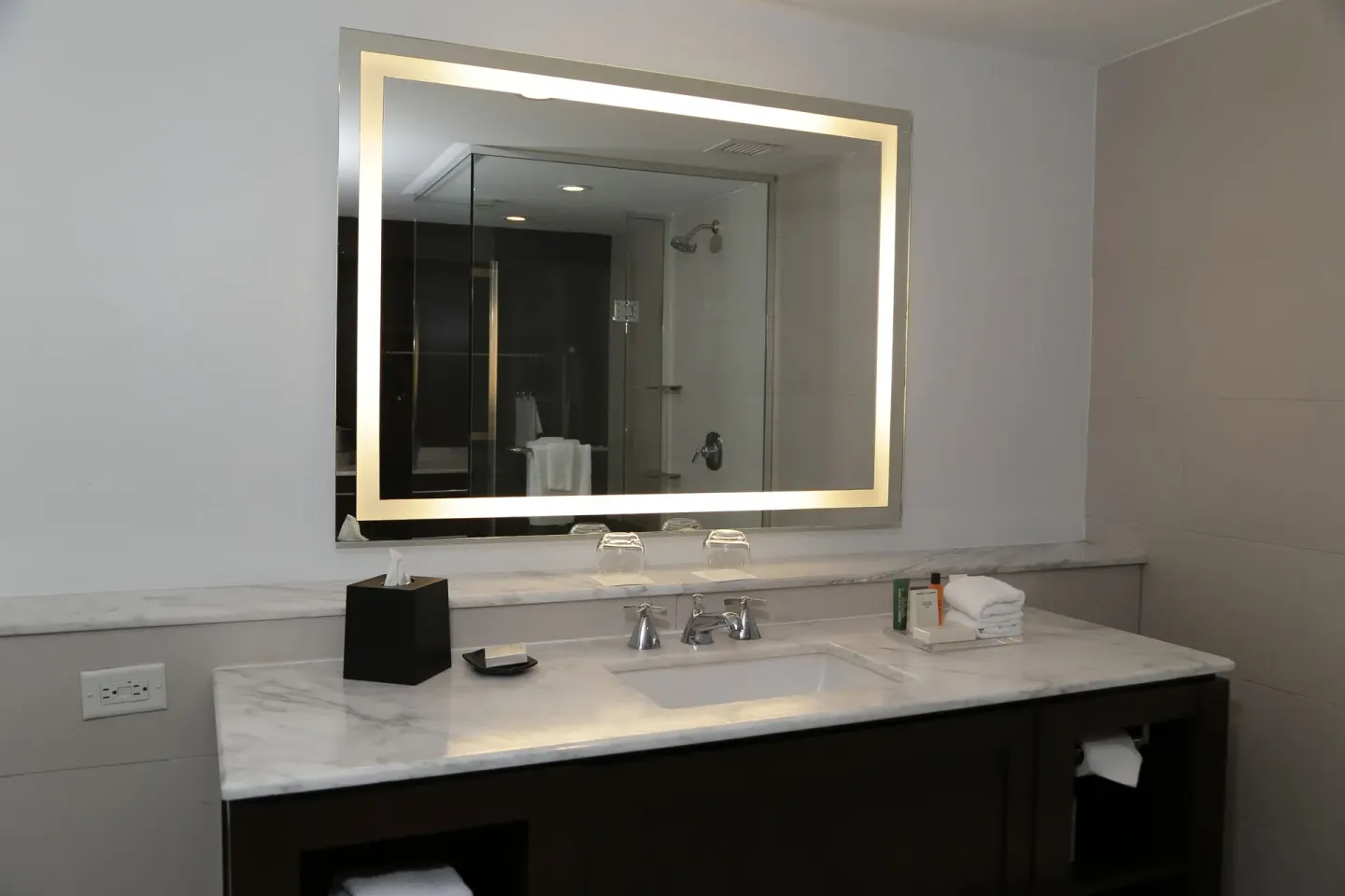 Oceanfront penthouse suite bathroom vanity with lighted mirror at The Condado Plaza Hotel.