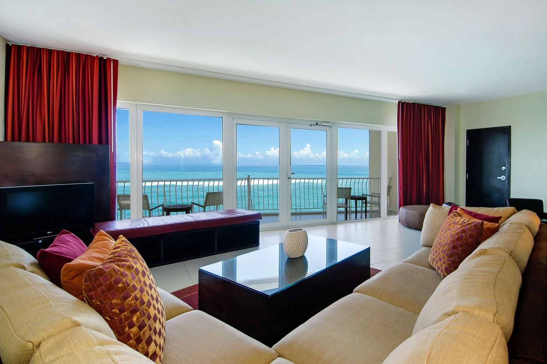 Penthouse Suite living Room at The Condado Plaza Hotel with upscale furnishings, floor-to-ceiling windows, and panoramic Atlantic Ocean views in San Juan, Puerto Rico.
