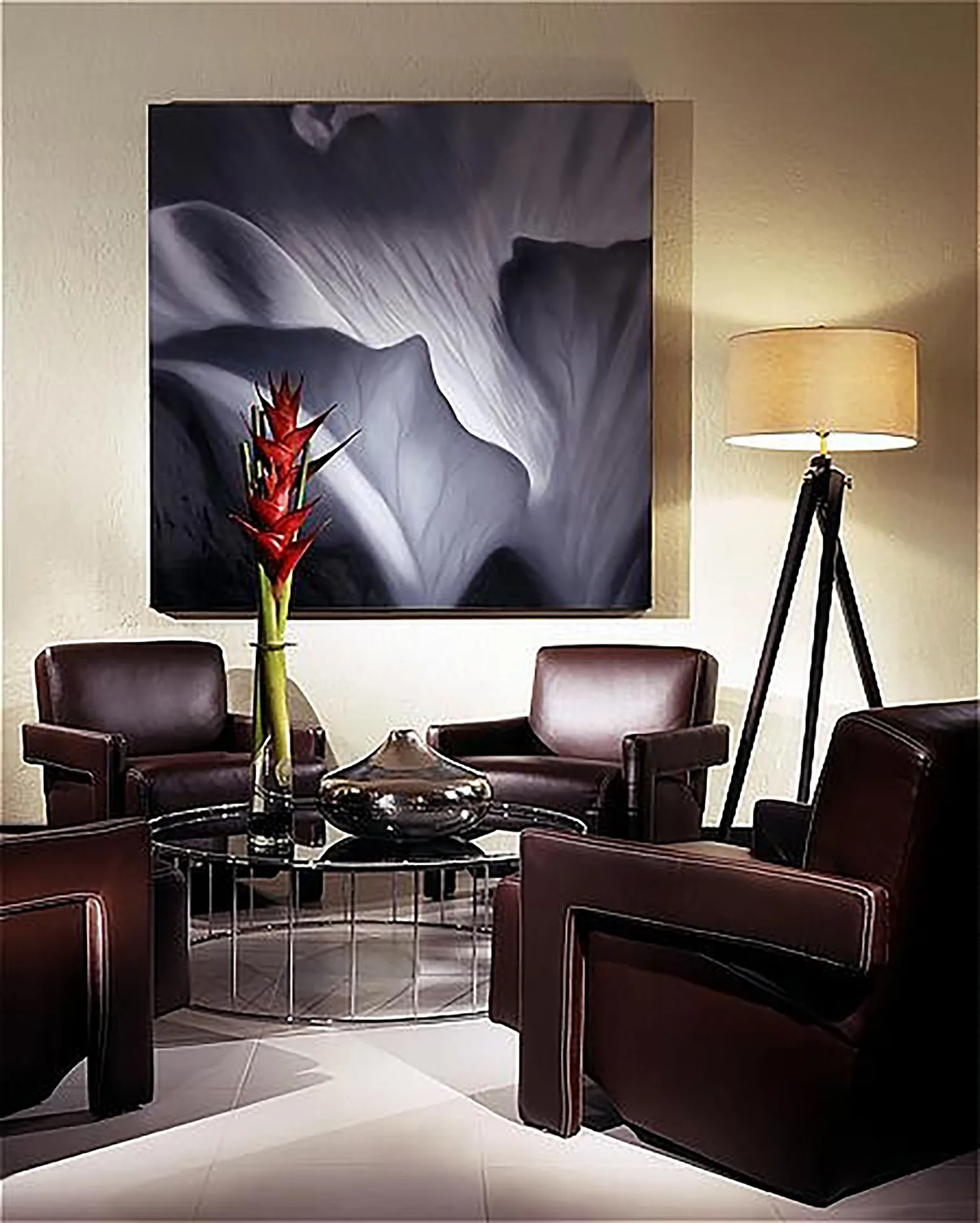 Seating area with leather chairs, flower art, and floor lamp in an oceanfront penthouse suite at The Condado Plaza Hotel.