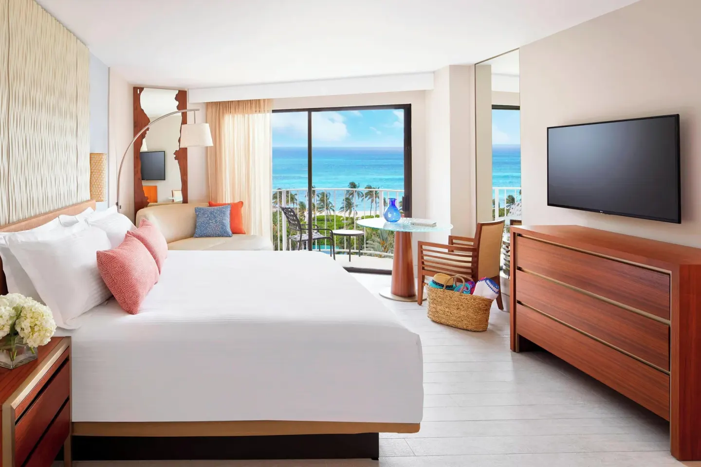King guest room with sofa, balcony, and ocean view at The Coral at Atlantis.