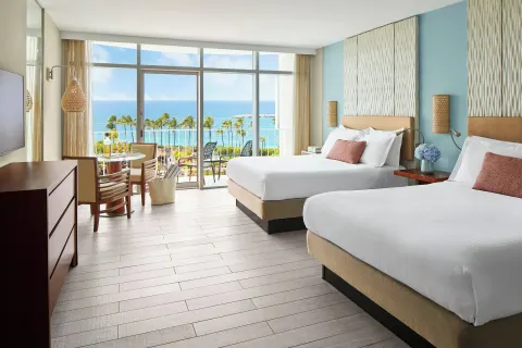 Double queen guest room with balcony and ocean view at The Coral at Atlantis.
