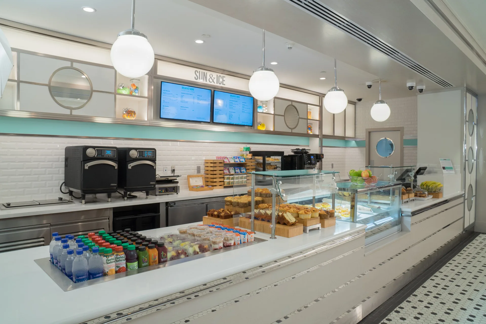 Sun & Ice counter with pastries, drinks, and display cases at The Coral at Atlantis.
