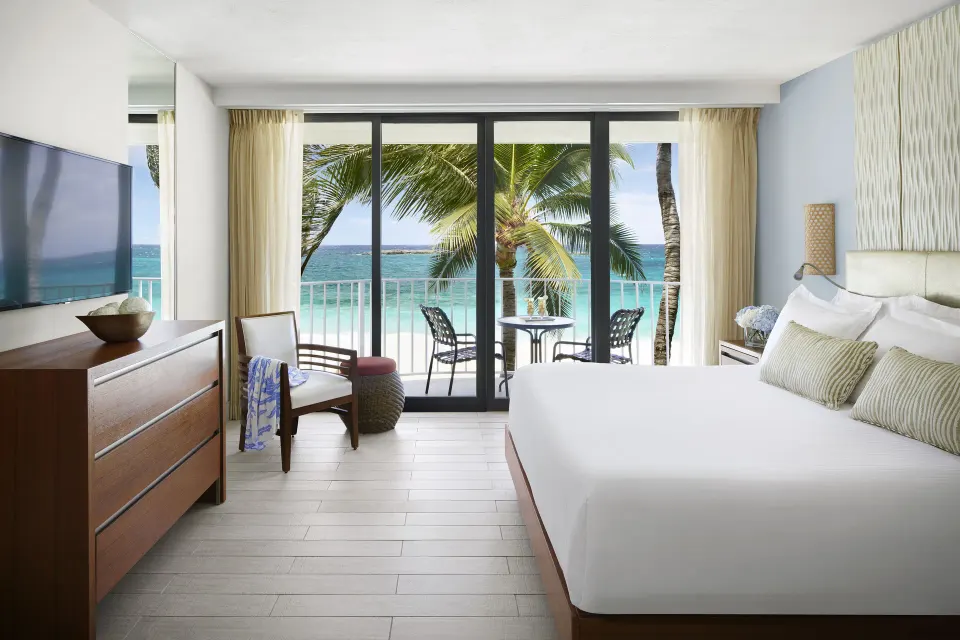 Bedroom in a 1 Bedroom Regal Suite at The Coral at Atlantis with ocean-facing balcony doors.