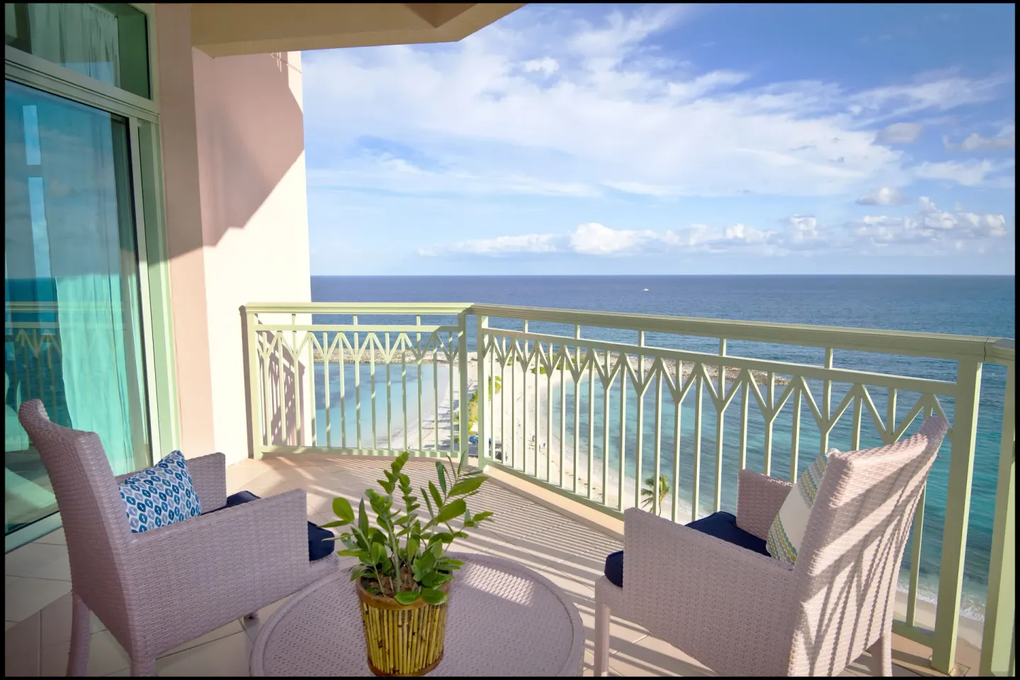 Ocean-view balcony of a 1 Bedroom Sapphire Suite at The Cove at Atlantis with chairs and a table.