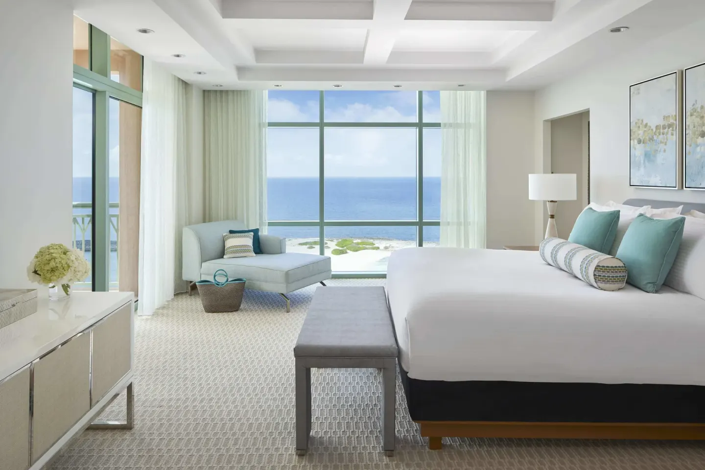 King bed in a 1 Bedroom Sapphire Suite at The Cove at Atlantis with ocean-facing windows.