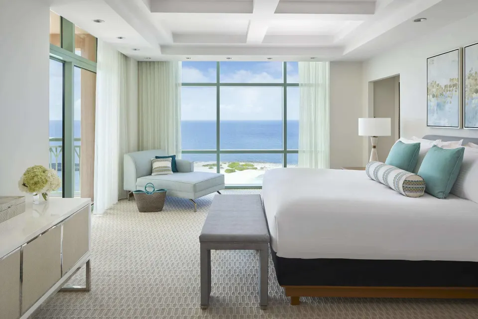 King bed in a 1 Bedroom Sapphire Suite at The Cove at Atlantis with ocean-facing windows.