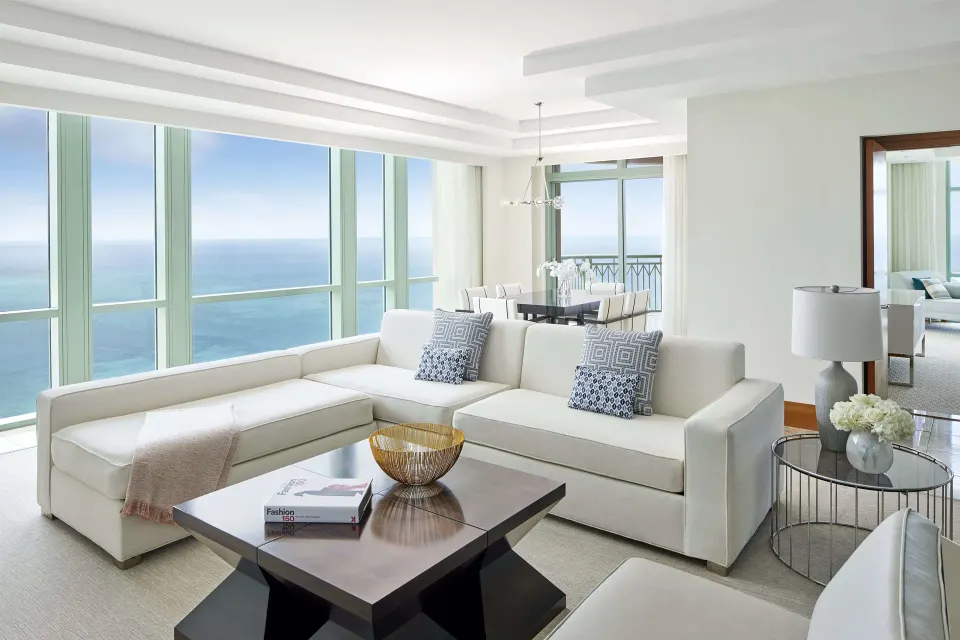 Living room in a 1 Bedroom Sapphire Suite at The Cove at Atlantis with ocean-view windows.