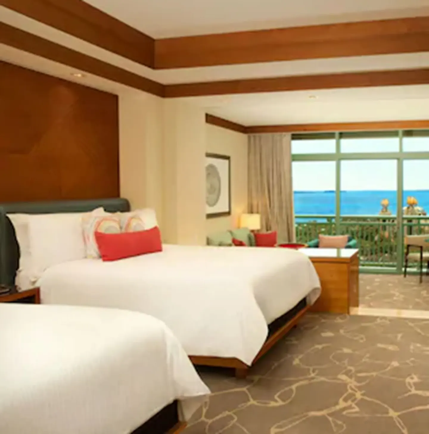 Deluxe Ocean Suite bedroom with two beds and balcony view at The Cove at Atlantis.
