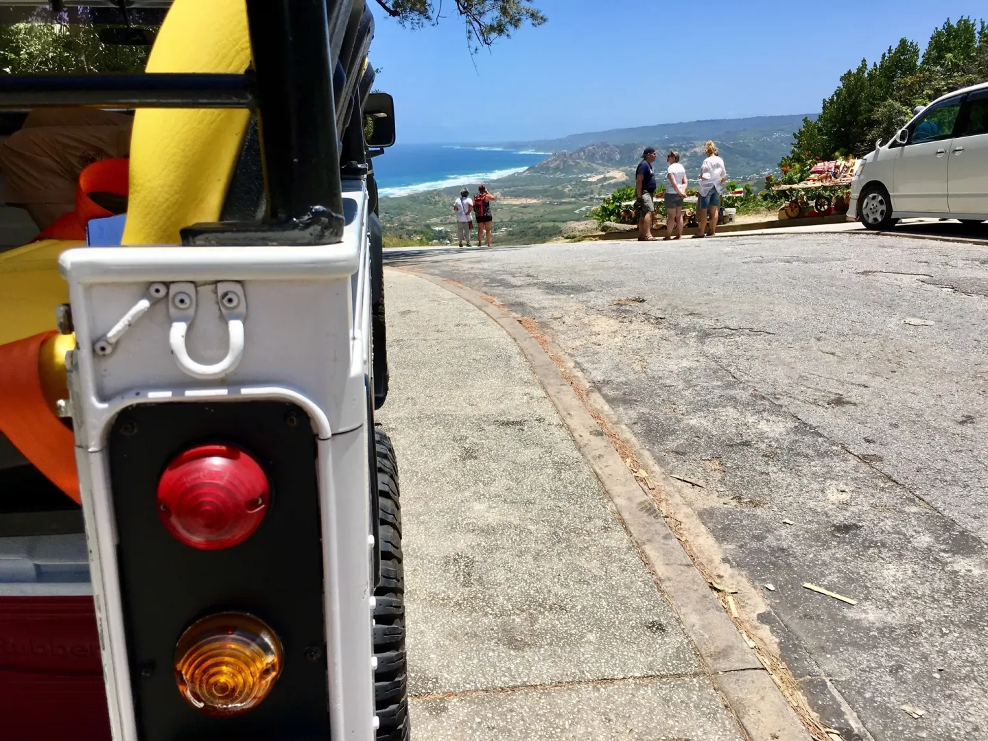 Open-air vehicle parked near a scenic coastal overlook by The Crane Resort.