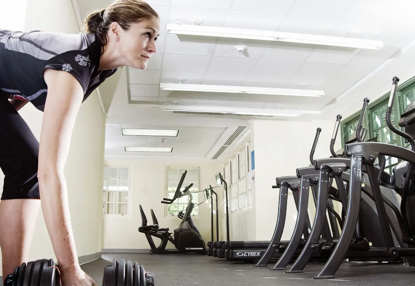 Guest lifts dumbbells in the fitness room at The Crane Resort.