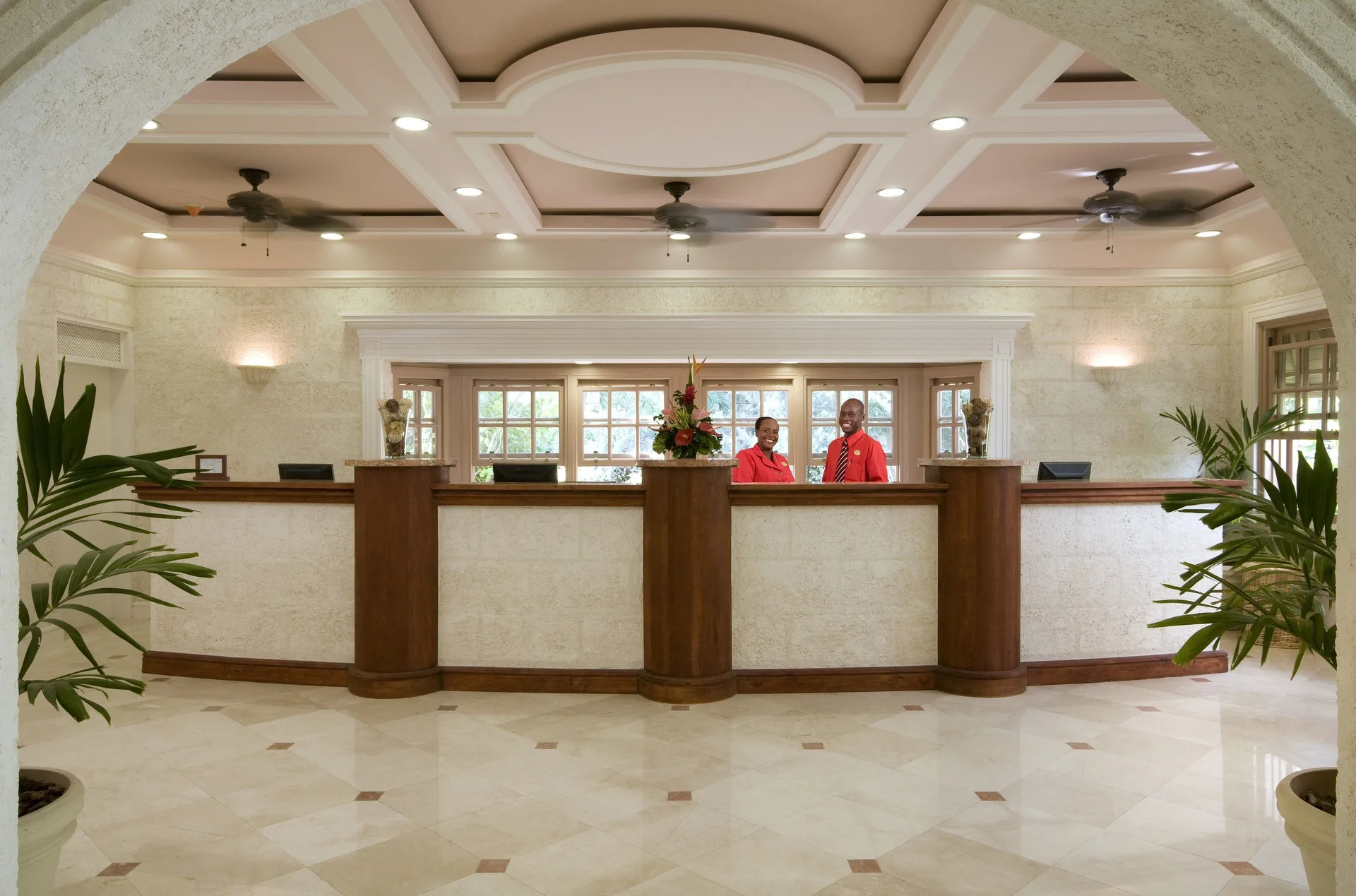 Reception desk with two staff members in the lobby at The Crane Resort.
