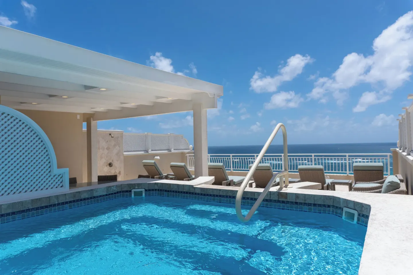 Rooftop-style pool deck with ocean view at The Crane Resort.