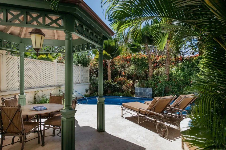 Private plunge pool patio with loungers and gazebo seating at The Crane Resort.
