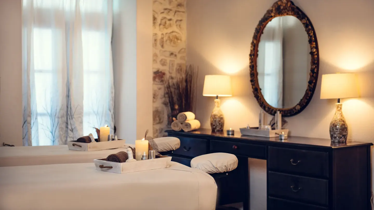 Spa treatment room with massage tables and soft lighting at The Crane Resort.