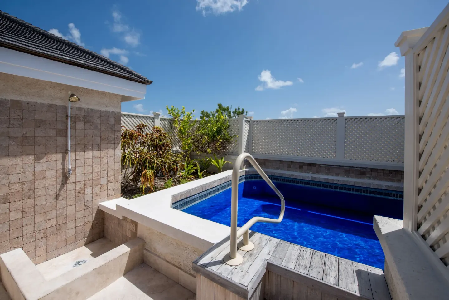 Walled plunge pool terrace with outdoor shower at The Crane Resort.