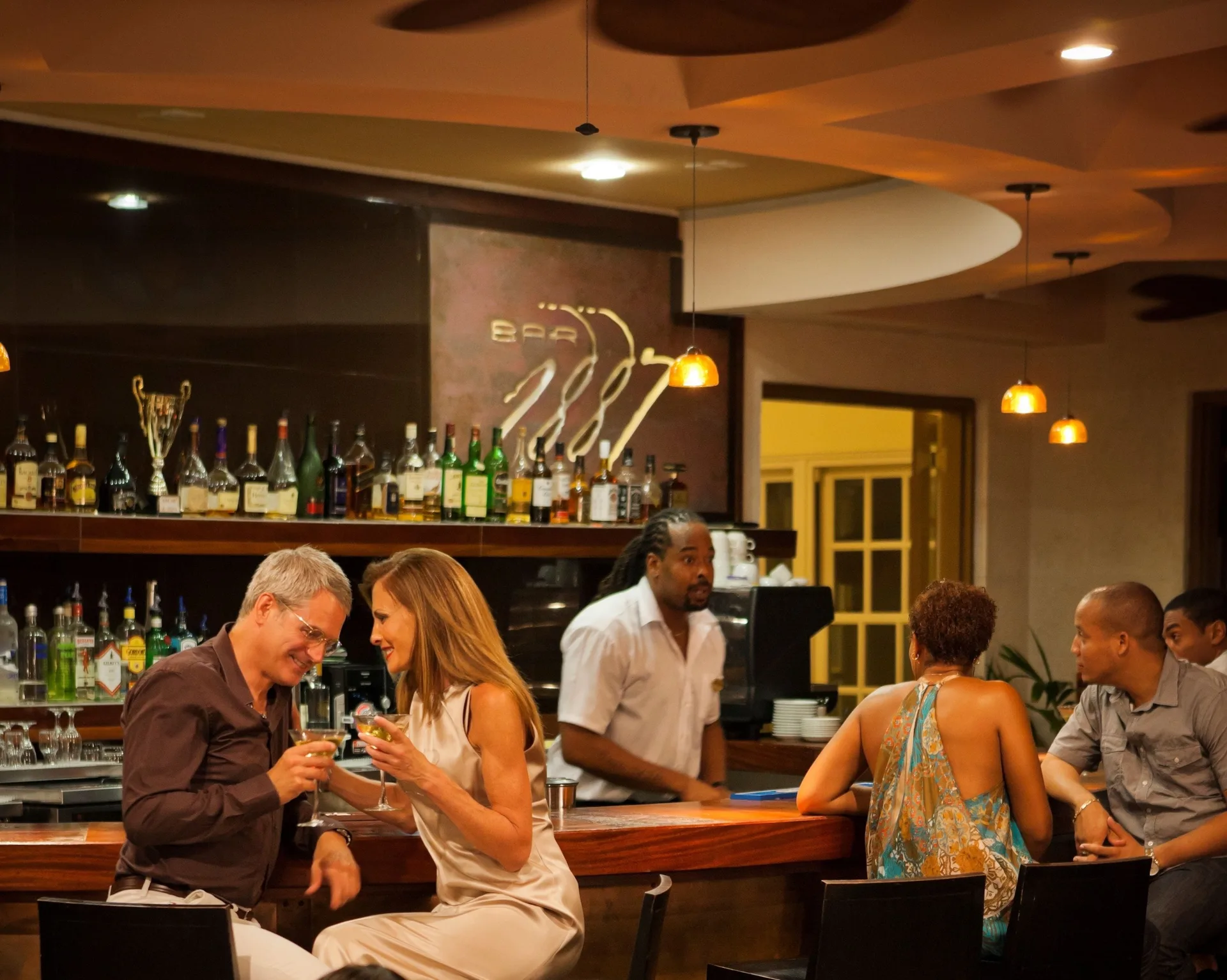Guests enjoy cocktails at Bar 1887 inside The Crane Resort.