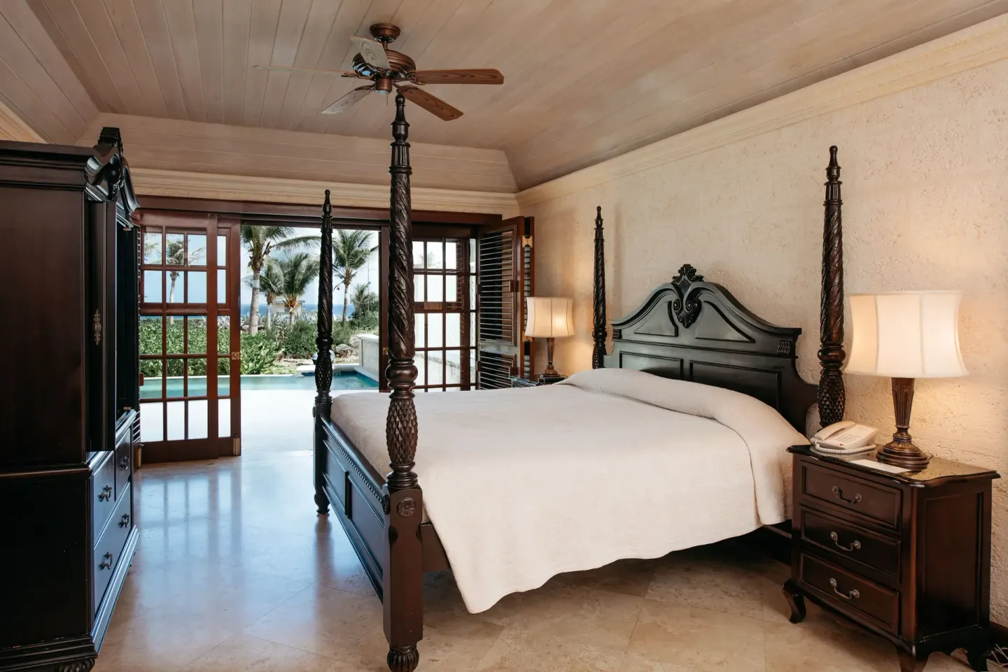 Four-poster bed in a 1 Bedroom Suite with pool terrace at The Crane Resort.