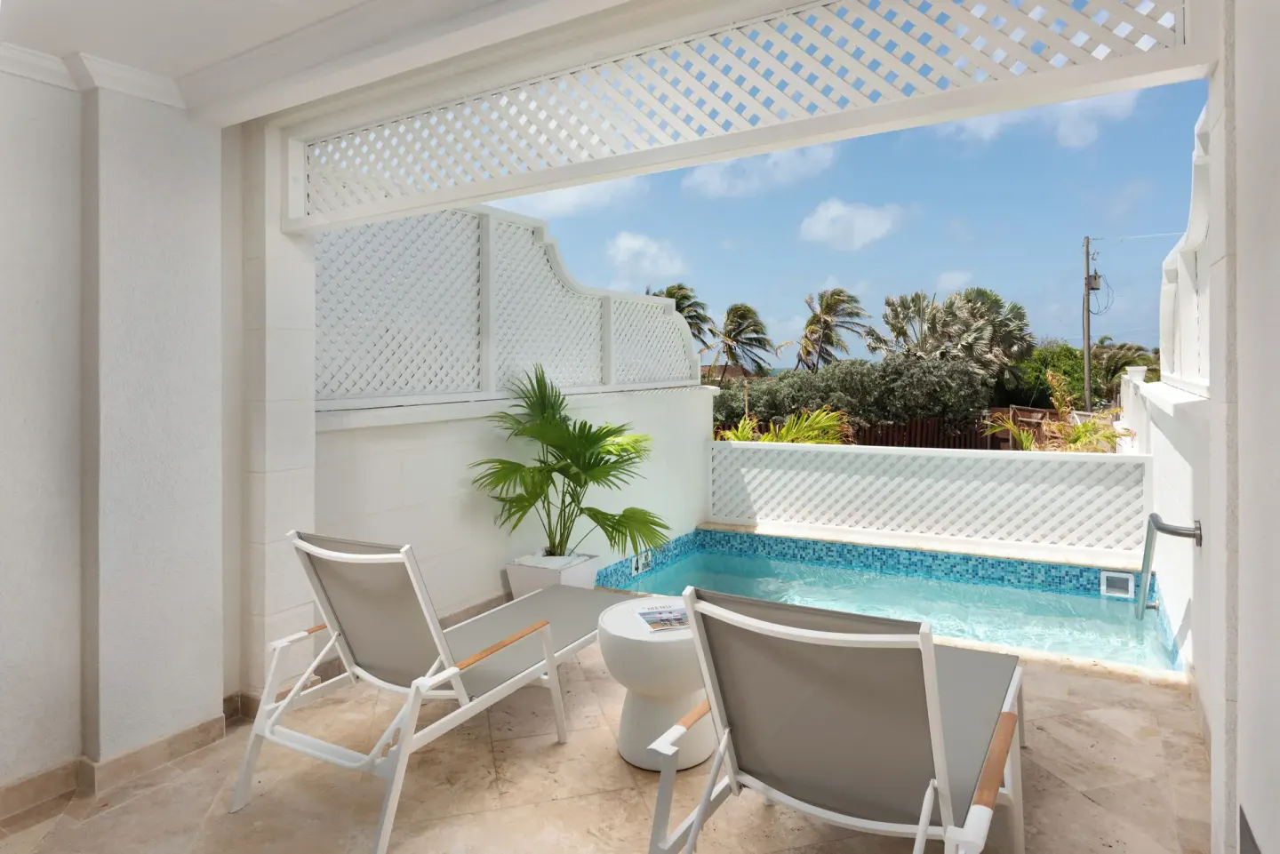 Junior Room private pool patio with loungers and garden view at The Crane Resort.