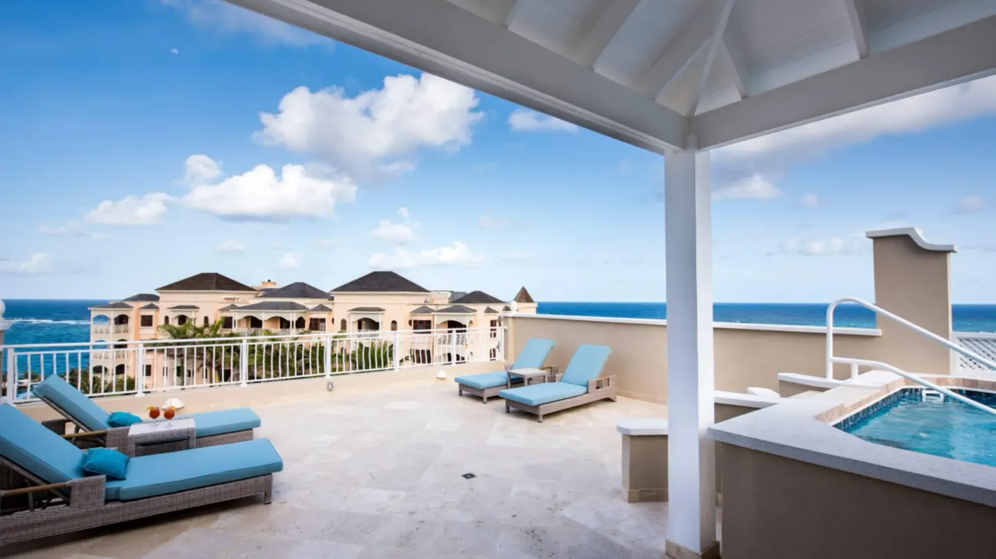 Penthouse terrace with private pool, loungers, and ocean view at The Crane Resort.