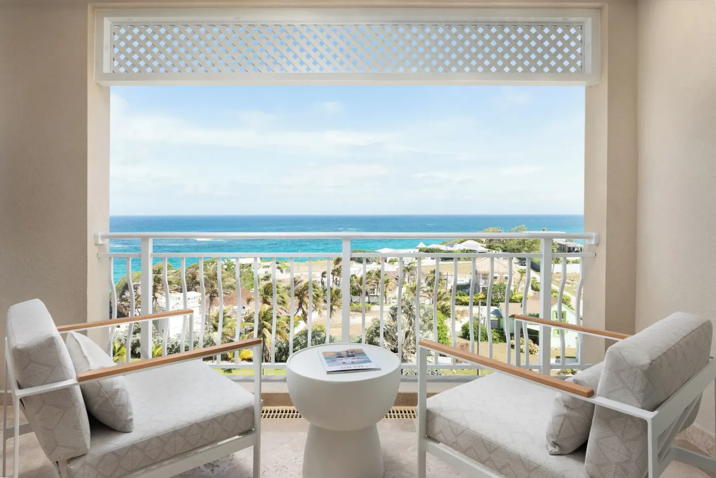 Balcony seating with partial ocean and resort views at The Crane Resort.