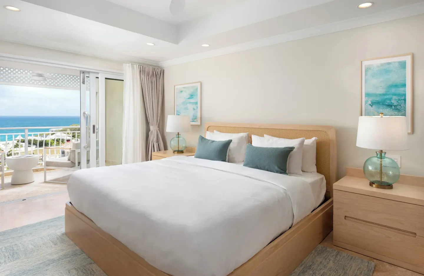 King bed in a Luxury Room with balcony and partial ocean view at The Crane Resort.