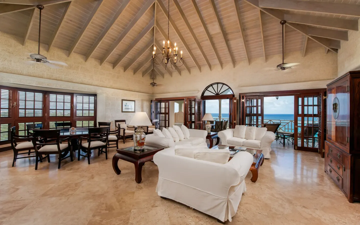 Vaulted living and dining room with ocean-view doors at The Crane Resort.
