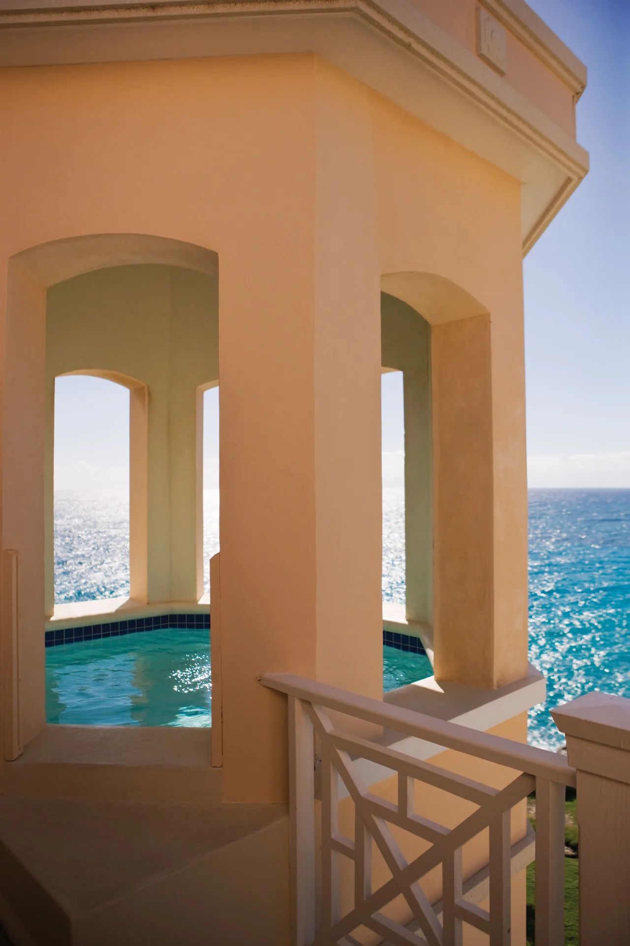 Ocean-view plunge pool on a suite balcony at The Crane Resort with arched openings.