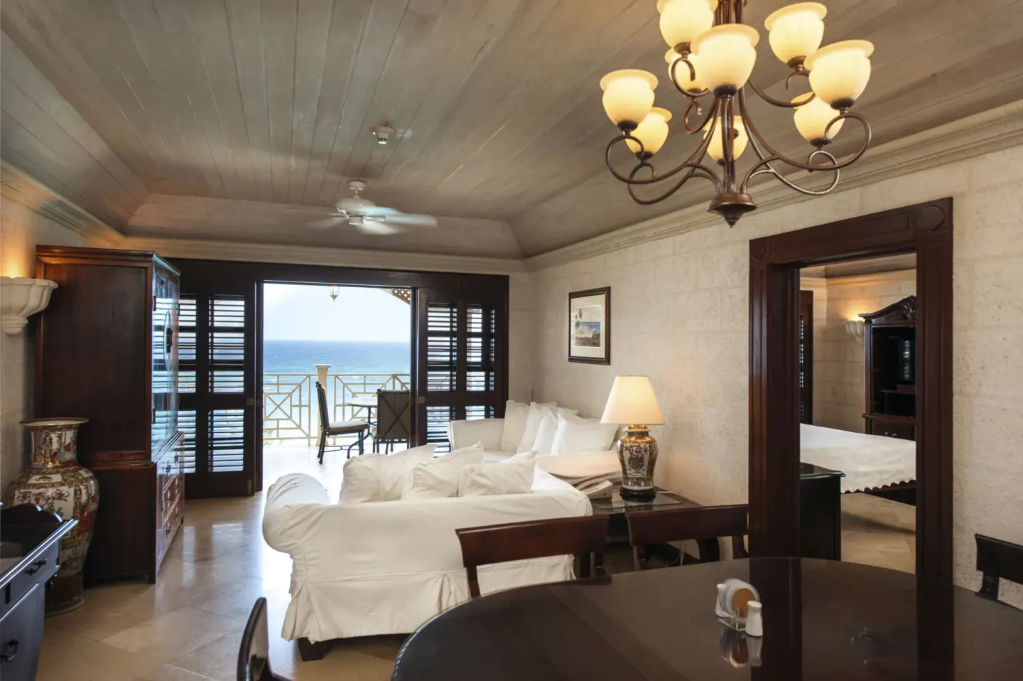 One-bedroom suite living room at The Crane Resort with balcony doors open to an ocean view.